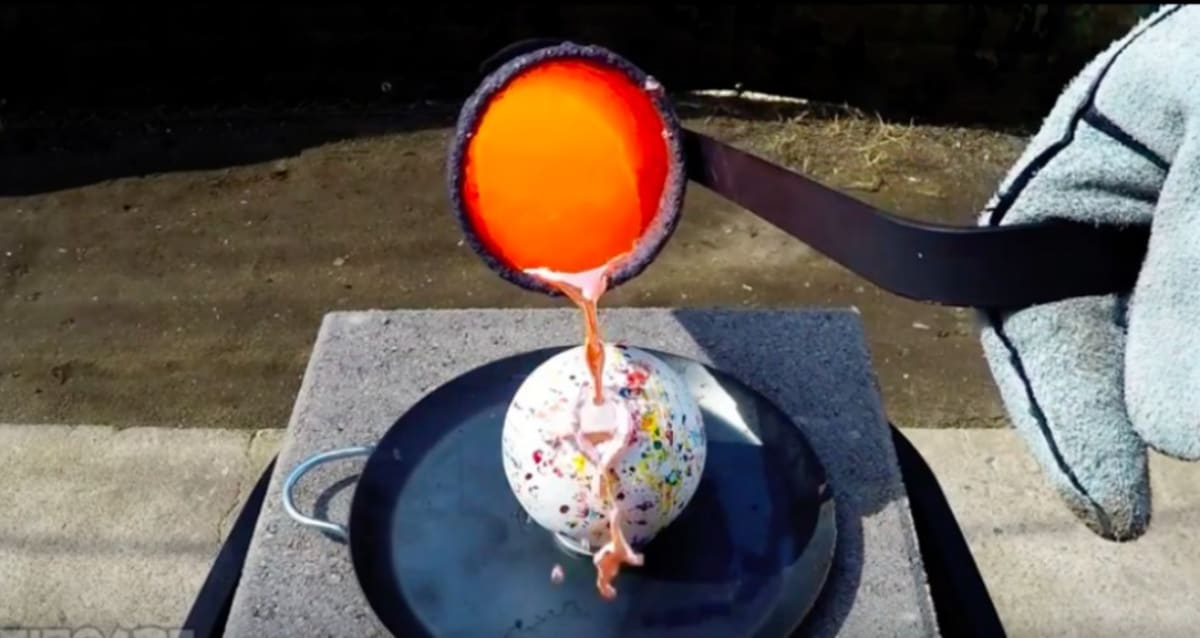 Watch What Happens When You Pour Molten Copper on to a Giant Jawbreaker